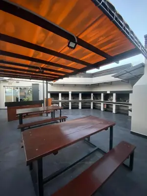 a group of picnic tables in a large room at Sueños in Villa Carlos Paz