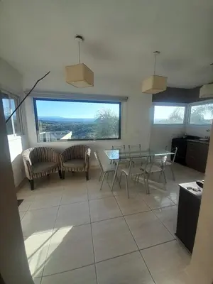 a living room with a table and chairs at Ayres Serranos in Villa Carlos Paz