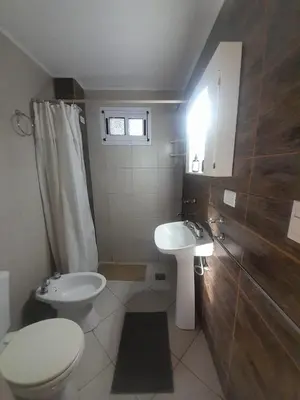 a bathroom with a toilet and a sink at Ayres Serranos in Villa Carlos Paz