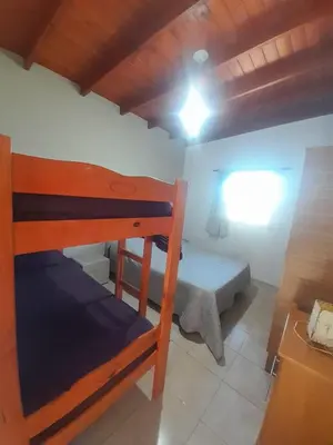 a small bedroom with a bunk bed and a table at Ayres Serranos in Villa Carlos Paz