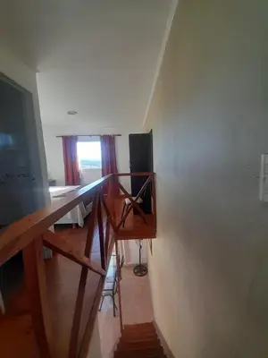 a room with a desk and a television and a window at Ayres Serranos in Villa Carlos Paz