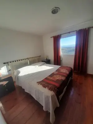 a bedroom with a large bed and a window at Ayres Serranos in Villa Carlos Paz