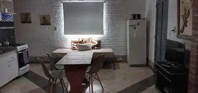 a kitchen with a table with a light on it at Cabañas Don Esteban in Las Chacras (La Paz)