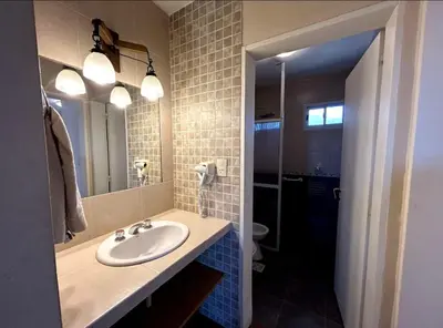 a bathroom with a sink and a mirror at La Rabona Cabañas in Las Rabonas