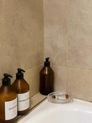 two bottles of soap sitting on top of a sink at Harmony Apart in Cordoba