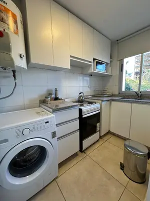 a kitchen with a washing machine and a sink at Harmony Apart in Cordoba