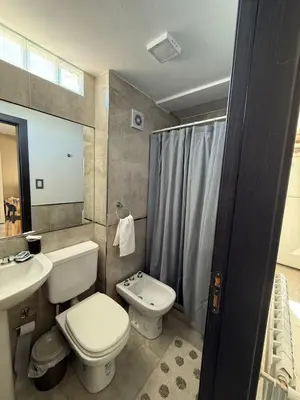 a bathroom with a toilet and a sink and a shower at DepartamentoxdiaVD in Villa Dolores