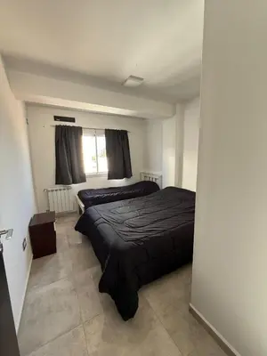 a bedroom with two beds and a window at DepartamentoxdiaVD in Villa Dolores