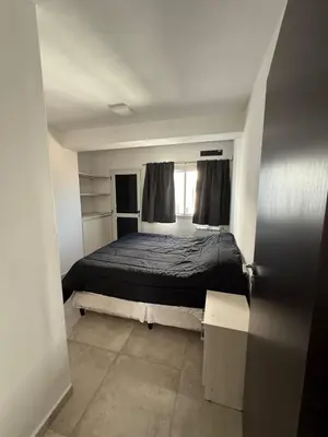 a small bedroom with a bed and a window at DepartamentoxdiaVD in Villa Dolores