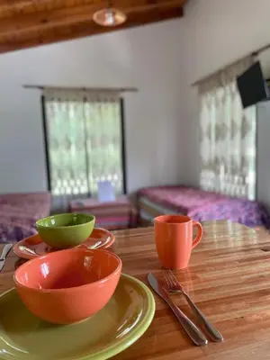 two bowls and two cups on a wooden table at Caminito in Los Reartes