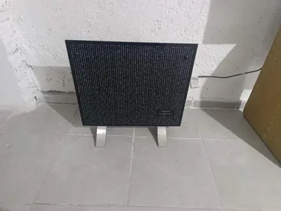 a black speaker sitting on a floor in a room at Departamento nubes in Cordoba