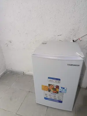 a white cooler sitting on the floor next to a wall at Departamento nubes in Cordoba