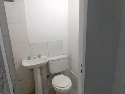 a white bathroom with a toilet and a sink at Departamento nubes in Cordoba