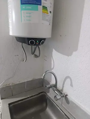 a kitchen sink with a water meter on the wall at Departamento nubes in Cordoba