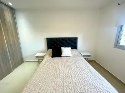 a bedroom with a large bed with two tables at Nova Urbs in Cordoba