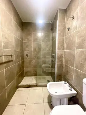 a bathroom with a shower and a toilet and a sink at Nova Urbs in Cordoba
