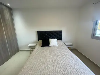 a bedroom with a large bed with a black headboard at Nova Urbs in Cordoba