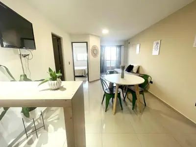 a living room with a table and a dining room at Nova Urbs in Cordoba