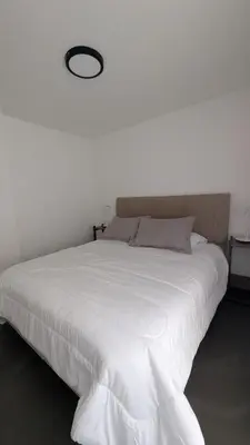 a bedroom with a large bed with a white bedspread at Apartamento de un dormitorio, Nueva Córdoba in Cordoba