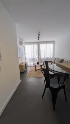a living room with a table and a chair at Apartamento de un dormitorio, Nueva Córdoba in Cordoba