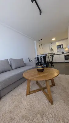 a living room with a couch and a wooden coffee table at Apartamento de un dormitorio, Nueva Córdoba in Cordoba