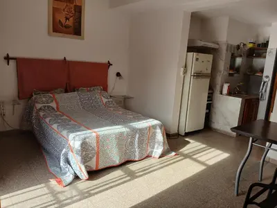 a small bedroom with a bed and a refrigerator at Tranquilidad y descanso in Cordoba