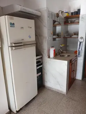 a kitchen with a white refrigerator and a sink at Tranquilidad y descanso in Cordoba