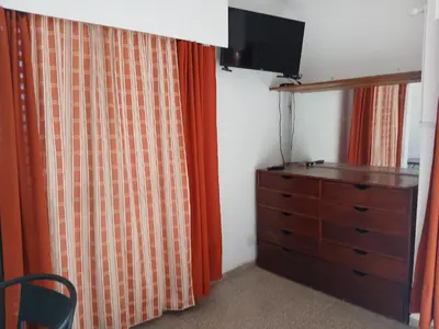 a bedroom with a dresser and a dresser with a television at Tranquilidad y descanso in Cordoba