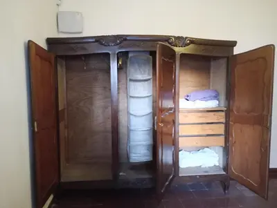 a wooden cabinet with two beds in a room at La casa de Mirta Habitaciones en Córdoba in Cordoba