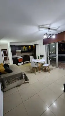 a bedroom with a bed and a table and chairs at Depto San Martín VCP in Villa Carlos Paz