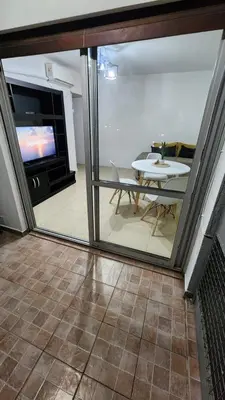 a view of a living room with a table and a tv at Depto San Martín VCP in Villa Carlos Paz