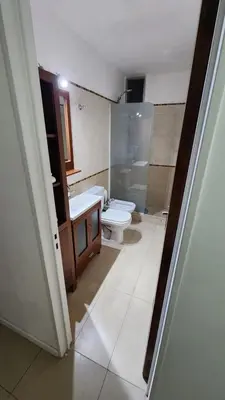 a bathroom with a toilet and a sink at Depto San Martín VCP in Villa Carlos Paz
