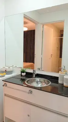 a bathroom counter with a sink and a mirror at Sam Gabrielll in Villa Carlos Paz