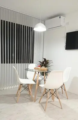 a dining room with white chairs and a table at Sam Gabrielll in Villa Carlos Paz