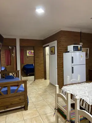 a living room with a white refrigerator in a room at Complejo Caeiro in Bialet Massé