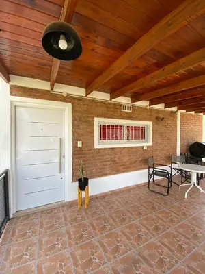 a garage with a white door and a brick wall at Complejo Caeiro in Bialet Massé