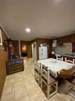 a kitchen and dining room with a table and chairs at Complejo Caeiro in Bialet Massé