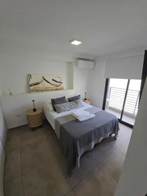 a bedroom with a bed with two towels on it at Dpto NVA CBA calle OBISPO TREJO con PILETA y QUINCHO in Cordoba