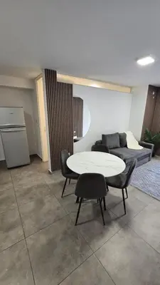 a living room with a table and a couch at Dpto NVA CBA calle OBISPO TREJO con PILETA y QUINCHO in Cordoba