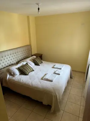 a bedroom with a bed with pillows on it at Bv San Juan - Nueva Cordoba 2 in Cordoba
