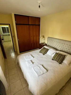 a bedroom with a large bed with towels on it at Bv San Juan - Nueva Cordoba 2 in Cordoba