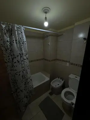 a bathroom with a toilet and a tub and a sink at Bv San Juan - Nueva Cordoba 2 in Cordoba