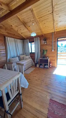 a living room with a table and a couch at Entre Sierras y Sueños in Villa Yacanto