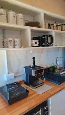 a kitchen counter with a coffee maker on top of it at Entre Sierras y Sueños in Villa Yacanto