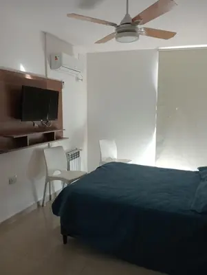 a bedroom with a bed and a ceiling fan at Departamento Carlos Paz Paseo Quattro 36 Cochera Piscina Céntrico in Villa Carlos Paz