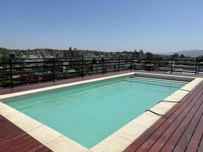 a swimming pool on the roof of a building at Departamento Carlos Paz Paseo Quattro 36 Cochera Piscina Céntrico in Villa Carlos Paz