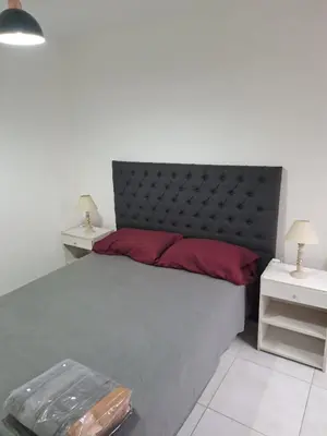 a bedroom with a large bed and two night stands at Salguero Loft in Cordoba