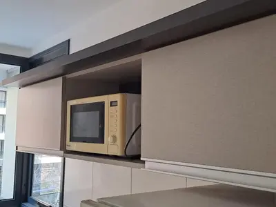 a microwave oven sitting on a shelf in a kitchen at Salguero Loft in Cordoba