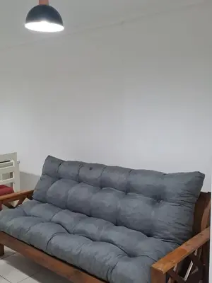 a gray couch in a room with a white wall at Salguero Loft in Cordoba