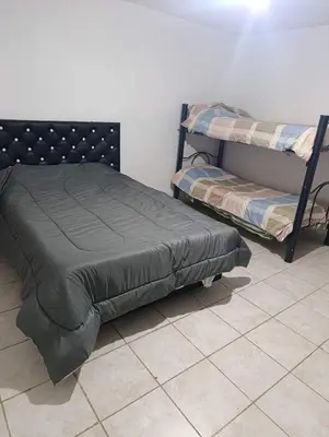 a bedroom with two bunk beds and a tiled floor at Departamento tolosa in Cordoba